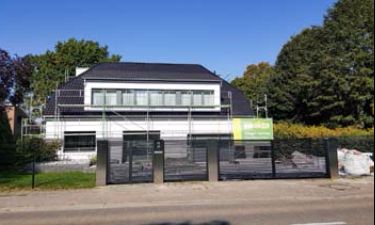 Strakke vleugelpoort bestaande uit stalen horizontale lammellen en RVS palen